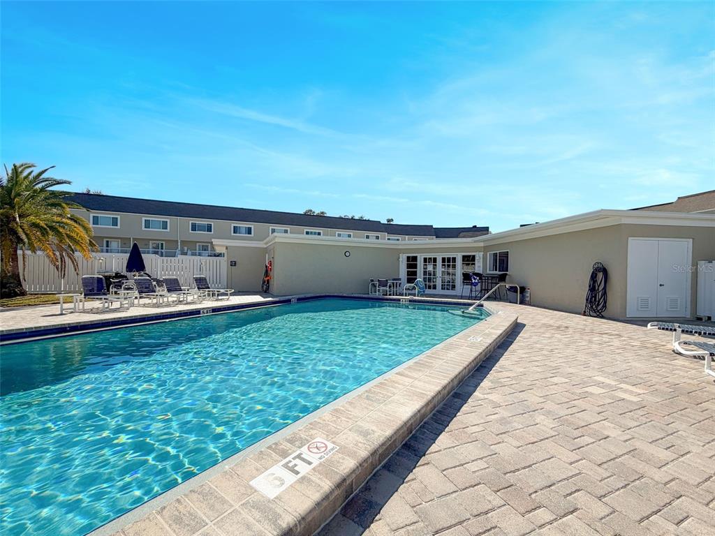 433 Paula Drive South, Unit 23 Dunedin, FL 34698 - Photo 49 of 56 a view of a house with a yard and sitting area