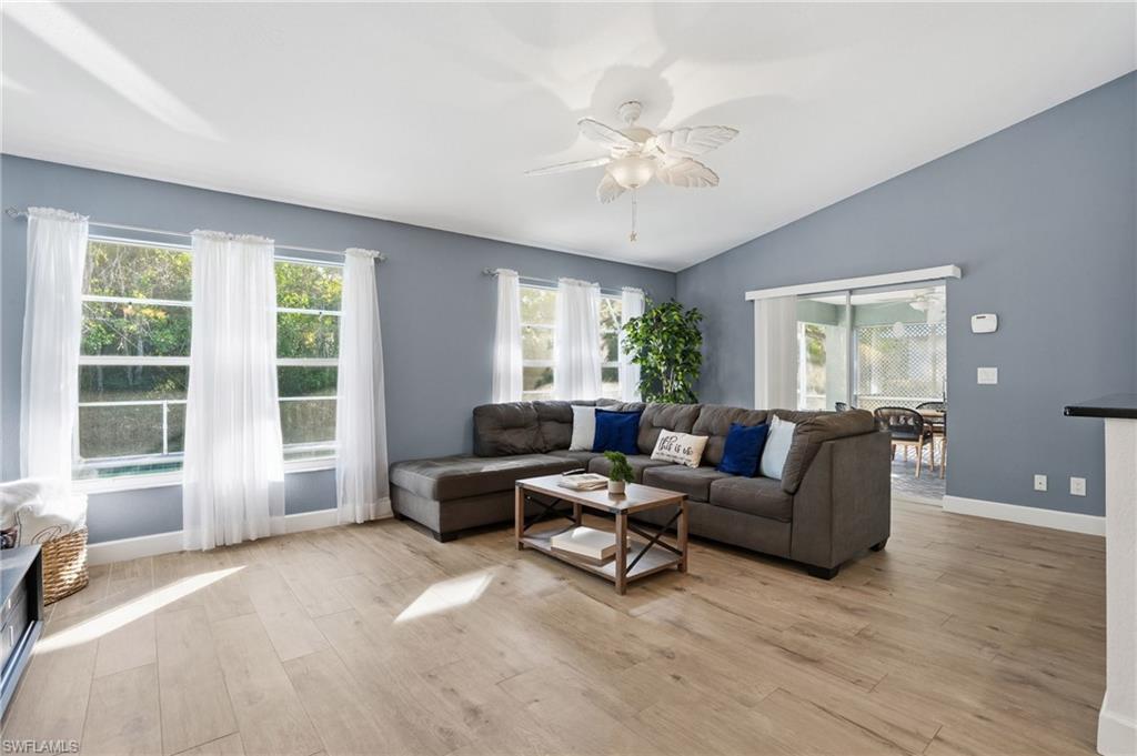 272 Johnnycake Drive Naples, FL 34110 - Photo 11 of 33 a living room with furniture and a large window