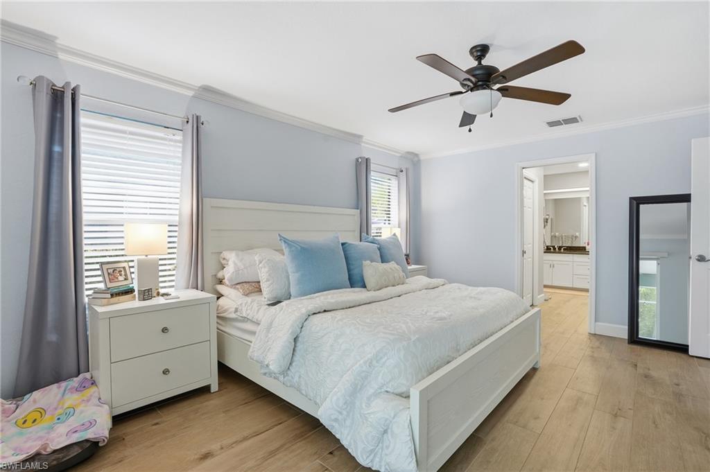 272 Johnnycake Drive Naples, FL 34110 - Photo 12 of 33 a spacious bedroom with a bed and a large window