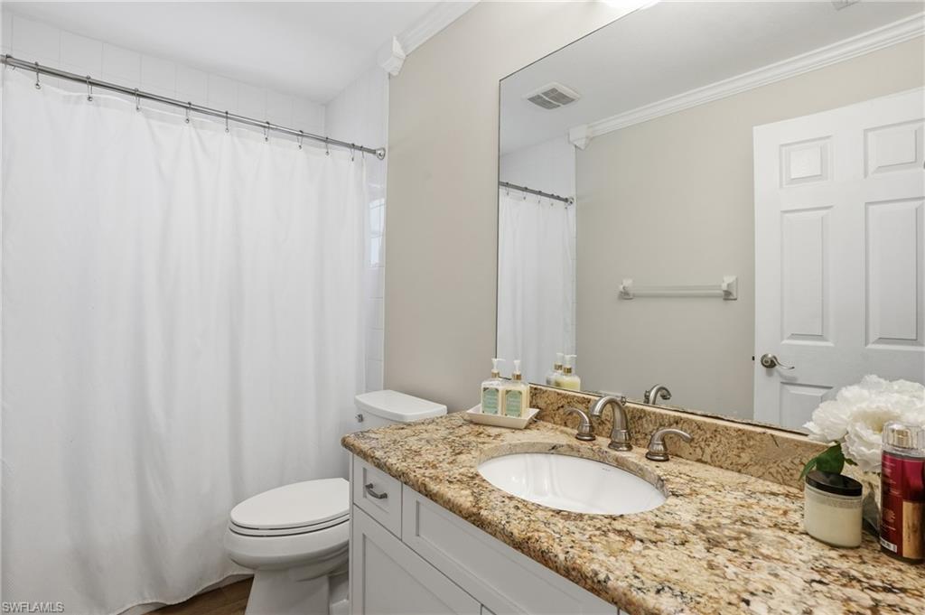 272 Johnnycake Drive Naples, FL 34110 - Photo 19 of 33 a bathroom with a granite countertop sink and a mirror