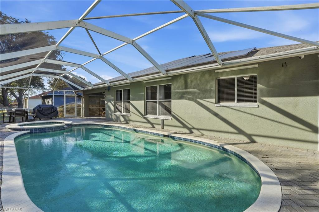 272 Johnnycake Drive Naples, FL 34110 - Photo 22 of 33 a view of a white house with a swimming pool