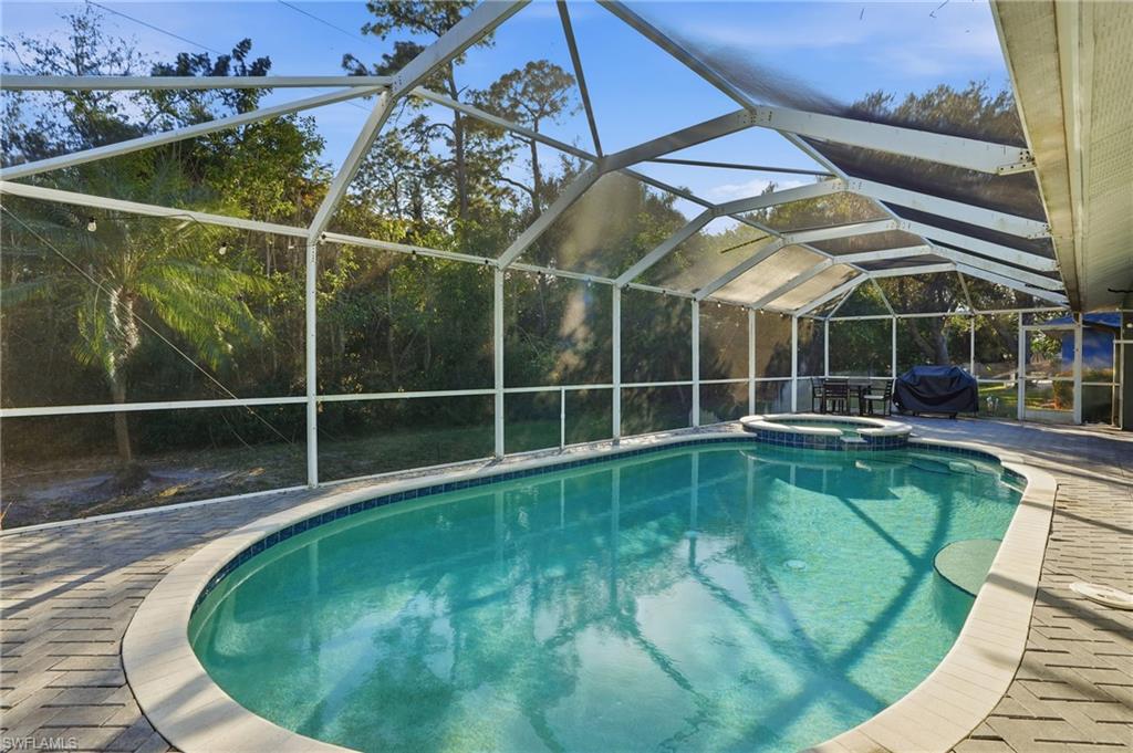 272 Johnnycake Drive Naples, FL 34110 - Photo 24 of 33 a view of a swimming pool with a patio and a yard