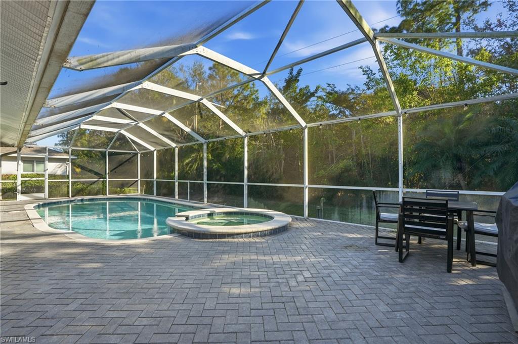 272 Johnnycake Drive Naples, FL 34110 - Photo 26 of 33 a view of a chair and table in the backyard