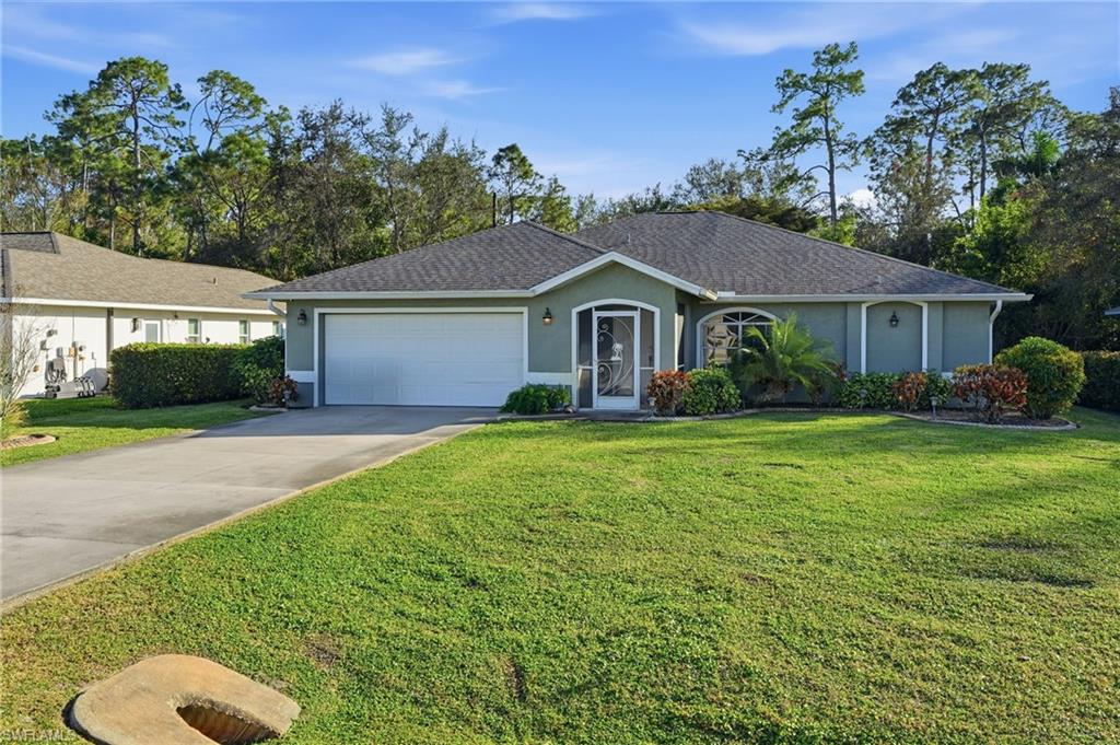 272 Johnnycake Drive Naples, FL 34110 - Photo 4 of 33 a front view of a house with garden