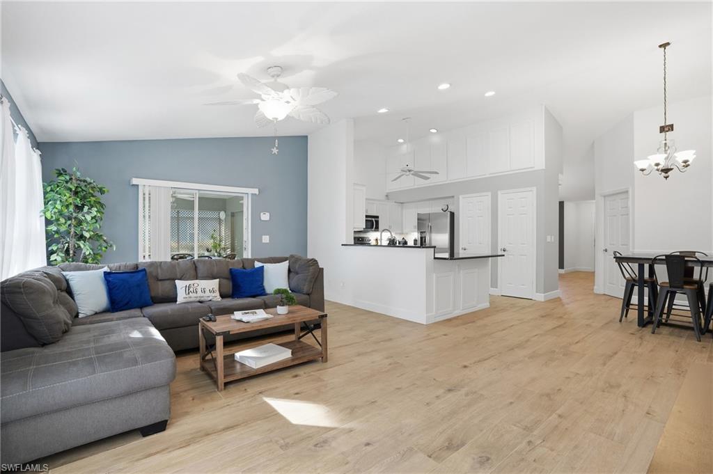272 Johnnycake Drive Naples, FL 34110 - Photo 9 of 33 a living room with furniture and kitchen view