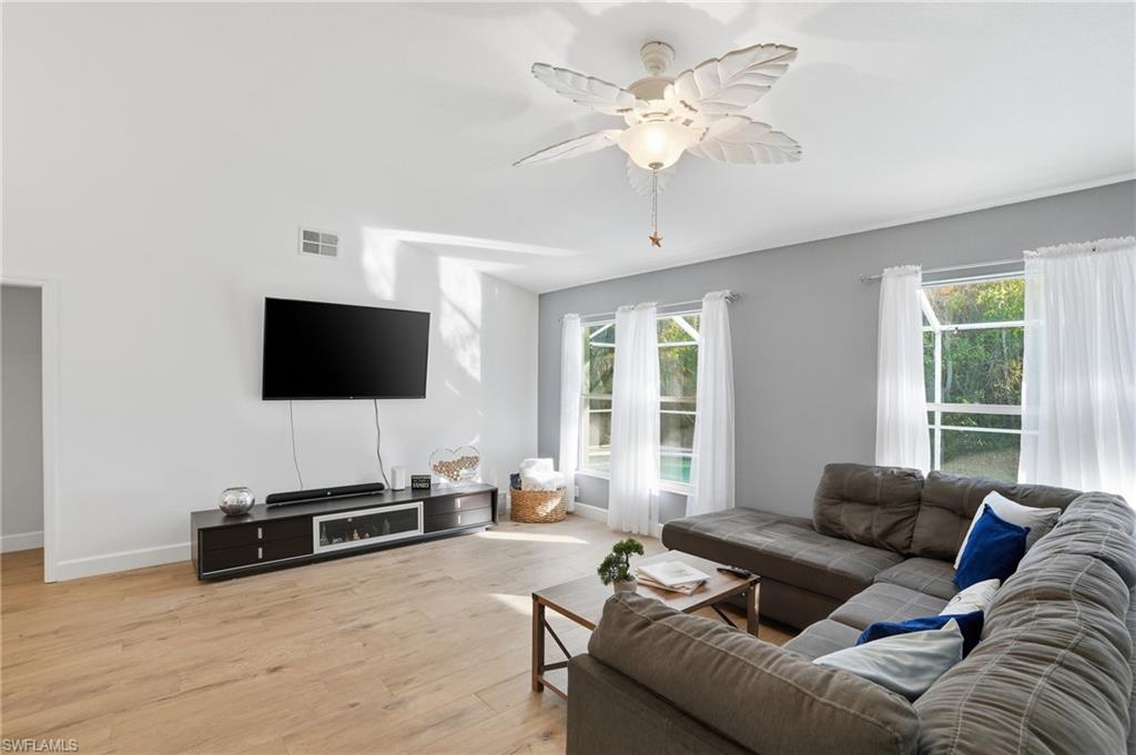 272 Johnnycake Drive Naples, FL 34110 - Photo 10 of 33 a living room with furniture and a flat screen tv