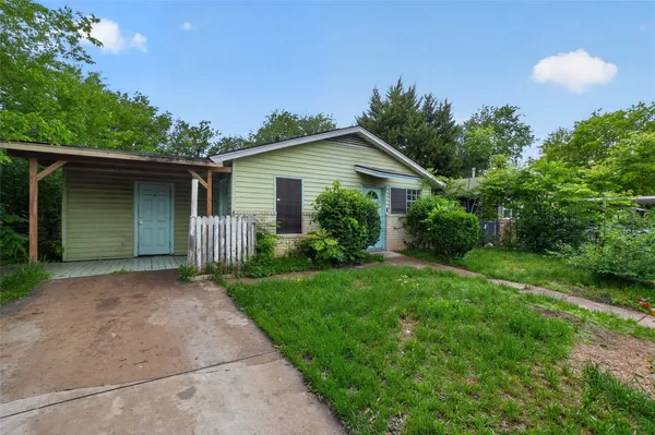 a front view of house with yard and trees