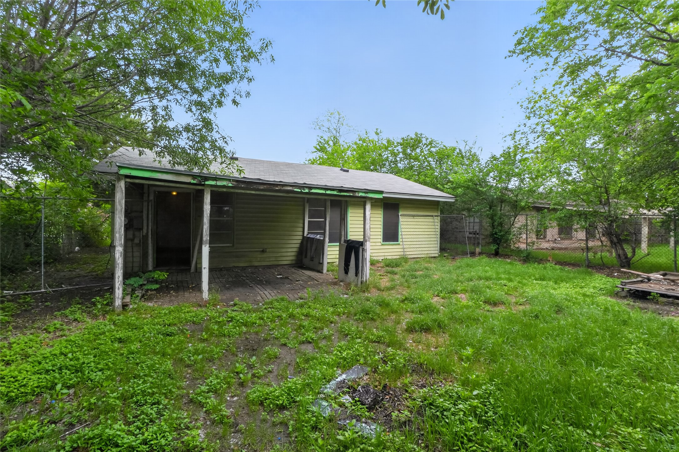 6015 Carnation Terrace Austin, TX 78741 - Photo 2 of 12 a backyard of a house with plants and large tree