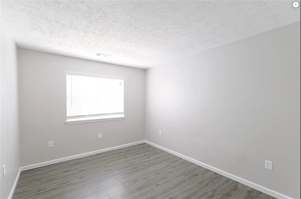 1108 Bridle Trail Coraopolis, PA 15108 - Photo 11 of 12 an empty room with wooden floor and windows