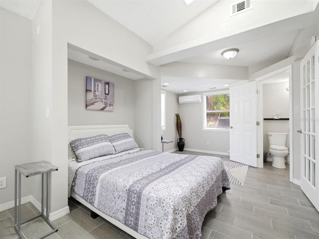 1207 1st Street Indian Rocks Beach, FL 33785 - Photo 23 of 60 a bedroom with a bed and a view of bathroom