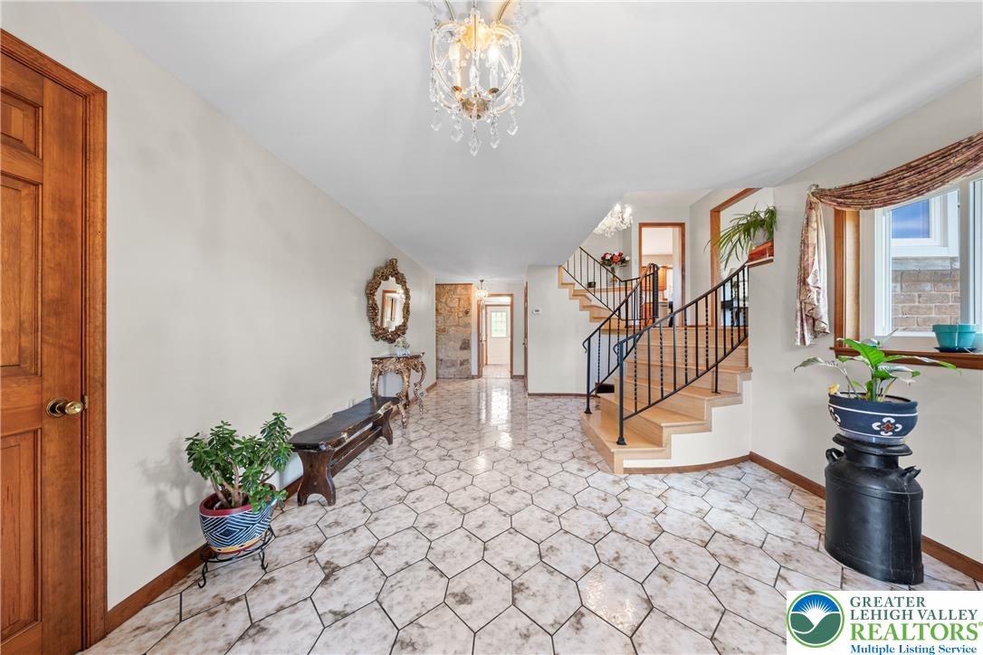 947 Tamenend Road Bath, PA 18014 - Photo 2 of 61 A graceful staircase with wrought iron railings highlights this well-lit entrance foyer.