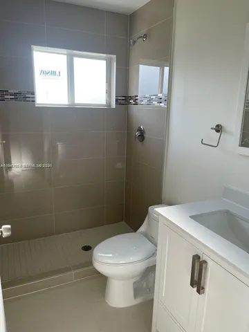 a bathroom with a toilet sink and window