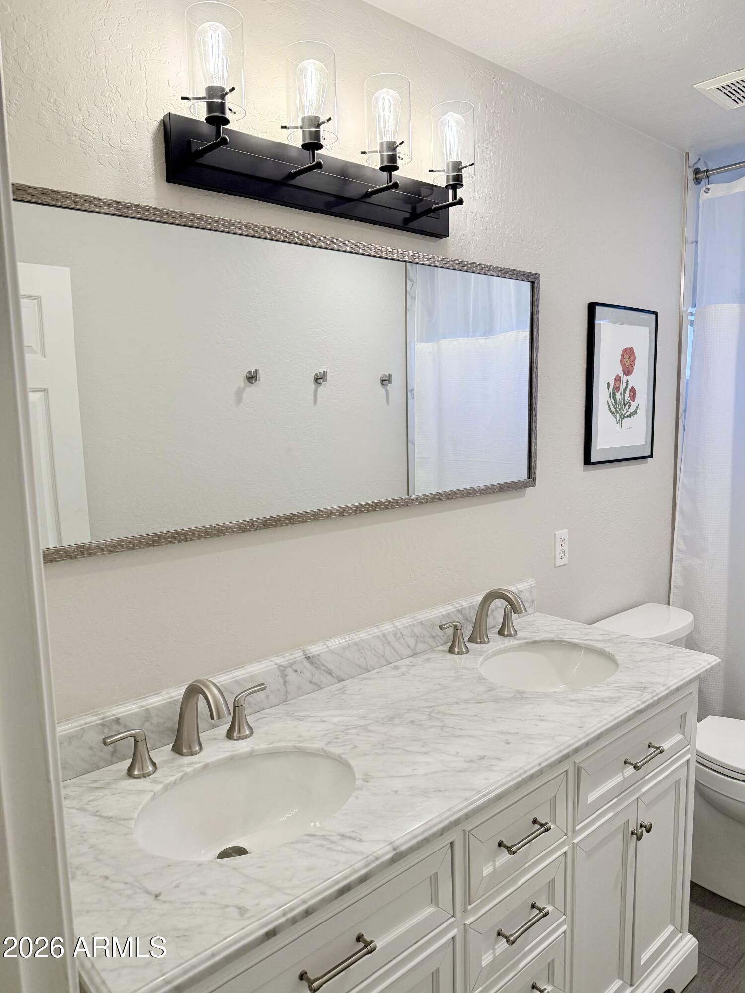 3426 East Clark Road Phoenix, AZ 85050 - Photo 29 of 48 a bathroom with a sink and a mirror