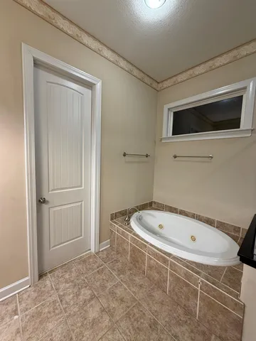 a bathroom with a tub and a shower