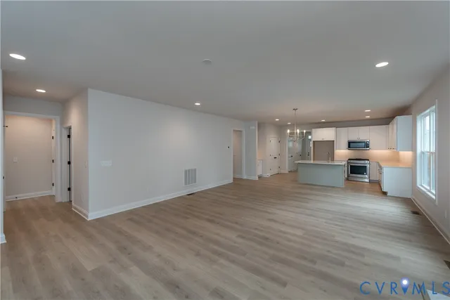 a view of a kitchen with a sink and a refrigerator