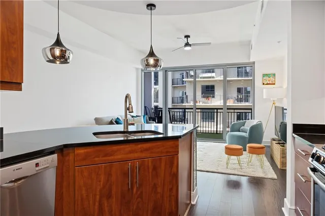 a kitchen with granite countertop cabinets stainless steel appliances and wooden cabinets