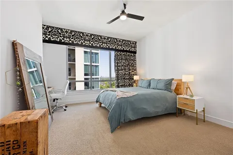 a bedroom with a bed and a chair