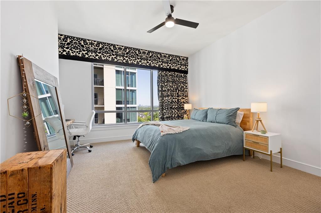 222 12th Street Northeast, Unit 1801 Atlanta, GA 30309 - Photo 18 of 50 a spacious bedroom with a bed couch and a window