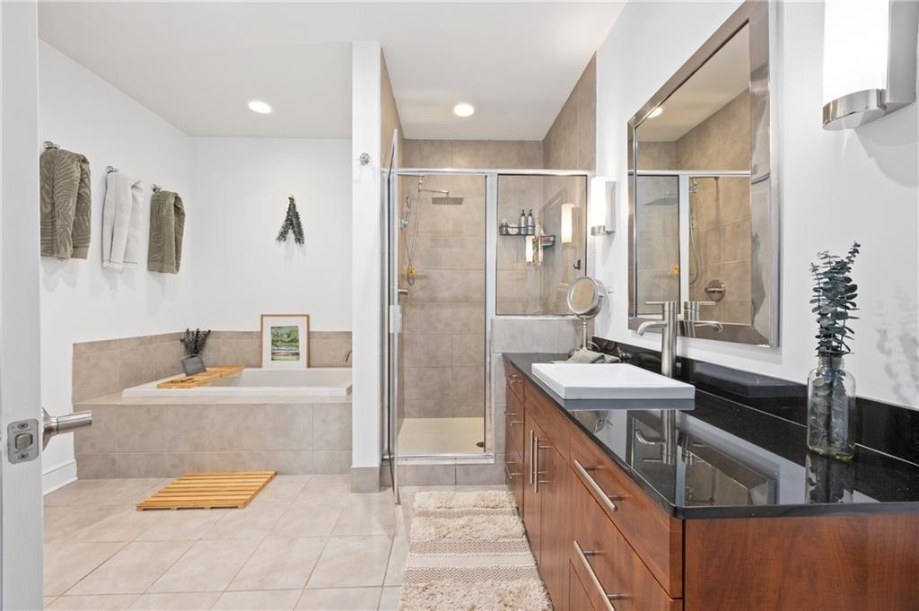 222 12th Street Northeast, Unit 1801 Atlanta, GA 30309 - Photo 21 of 50 a bathroom with a tub sink and mirror