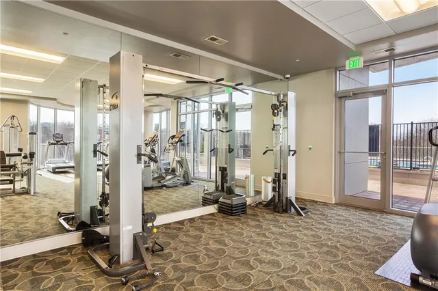 a room with gym equipment and a large window