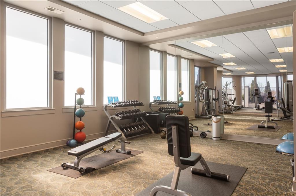 222 12th Street Northeast, Unit 1801 Atlanta, GA 30309 - Photo 33 of 50 a room with gym equipment and a large window
