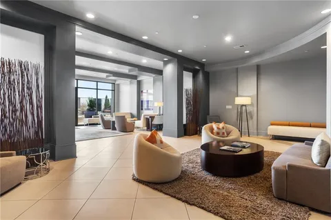 a living room with furniture and a potted plant