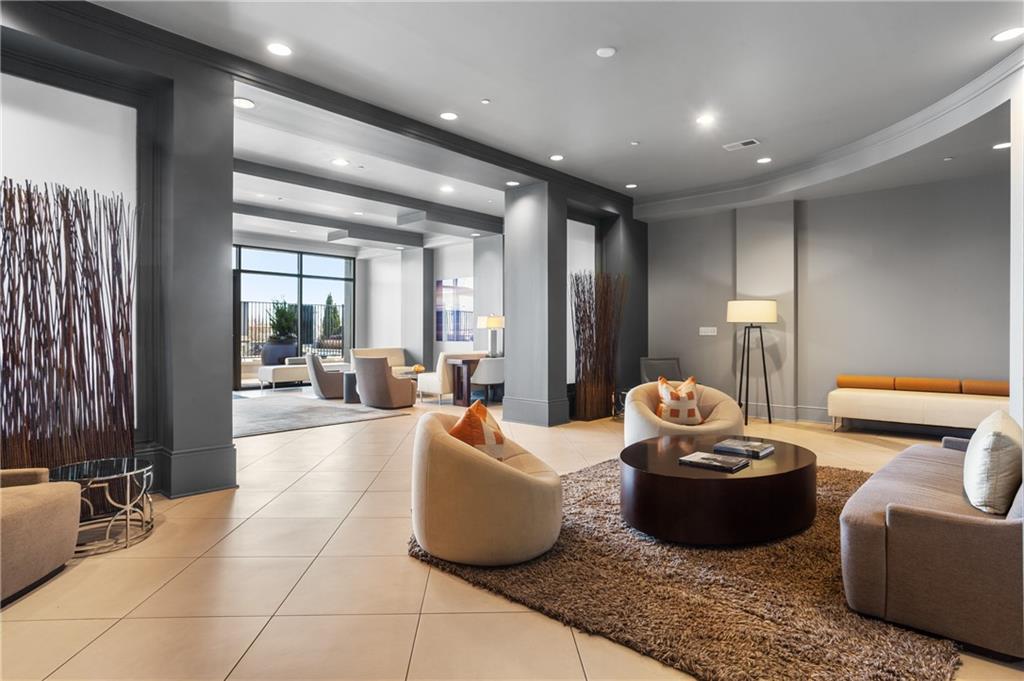 222 12th Street Northeast, Unit 1801 Atlanta, GA 30309 - Photo 34 of 50 a living room with furniture and a potted plant