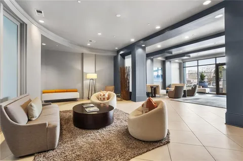 a living room with furniture and large windows