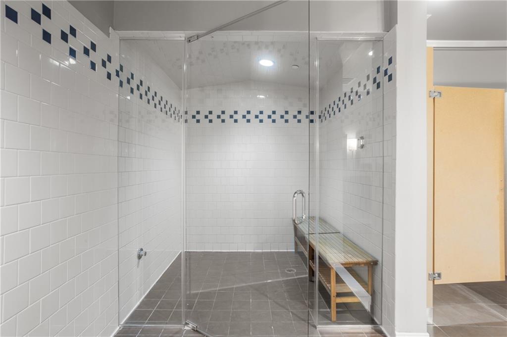 222 12th Street Northeast, Unit 1801 Atlanta, GA 30309 - Photo 45 of 50 a bathroom with a glass shower door and a bathtub