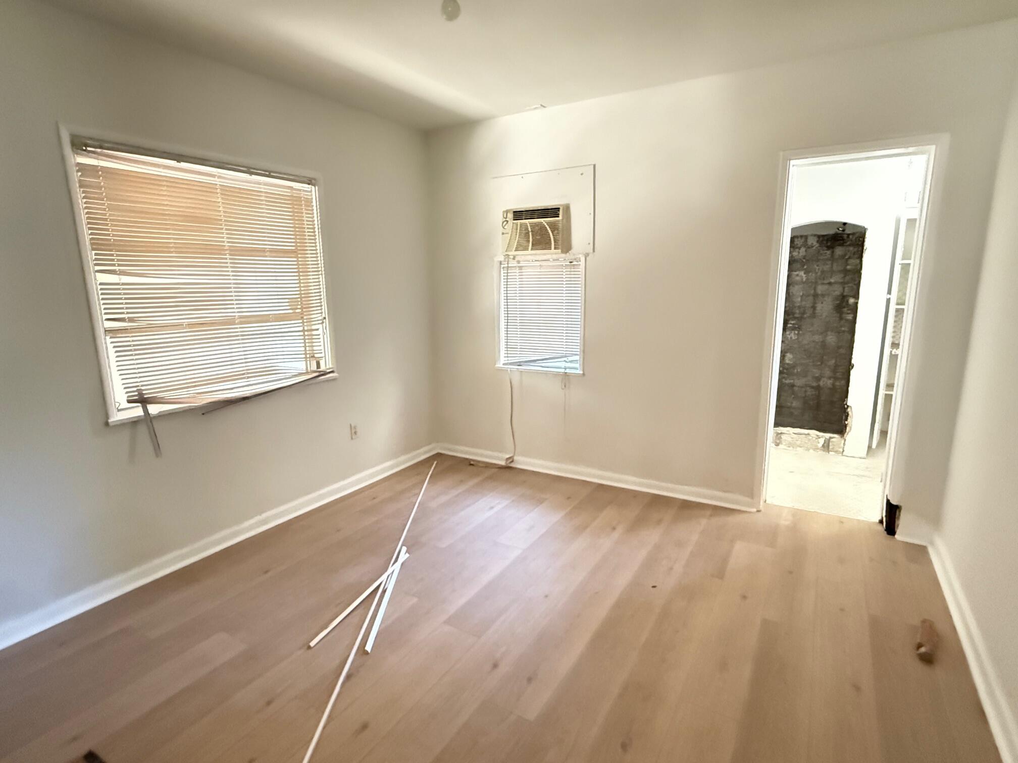 523 48th Street West Palm Beach, FL 33407 - Photo 12 of 33 a view of an empty room with wooden floor and a window
