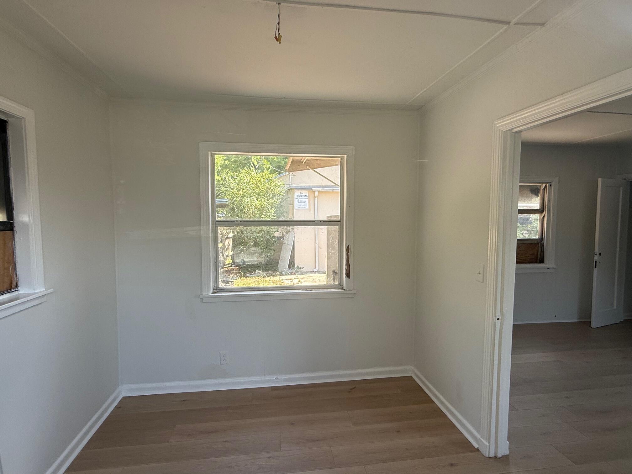 523 48th Street West Palm Beach, FL 33407 - Photo 16 of 33 an empty room with wooden floor and windows