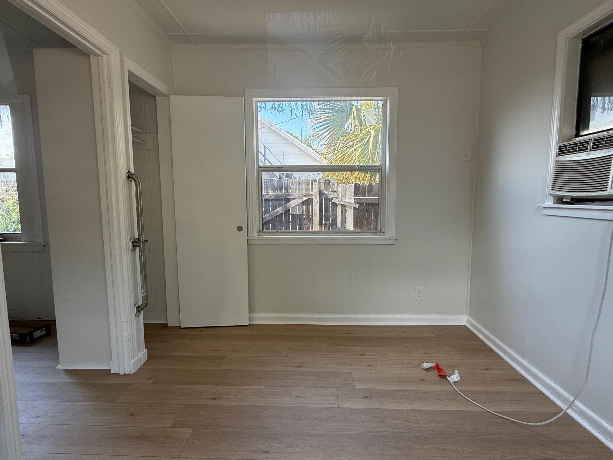 523 48th Street West Palm Beach, FL 33407 - Photo 18 of 33 an empty room with wooden floor and windows