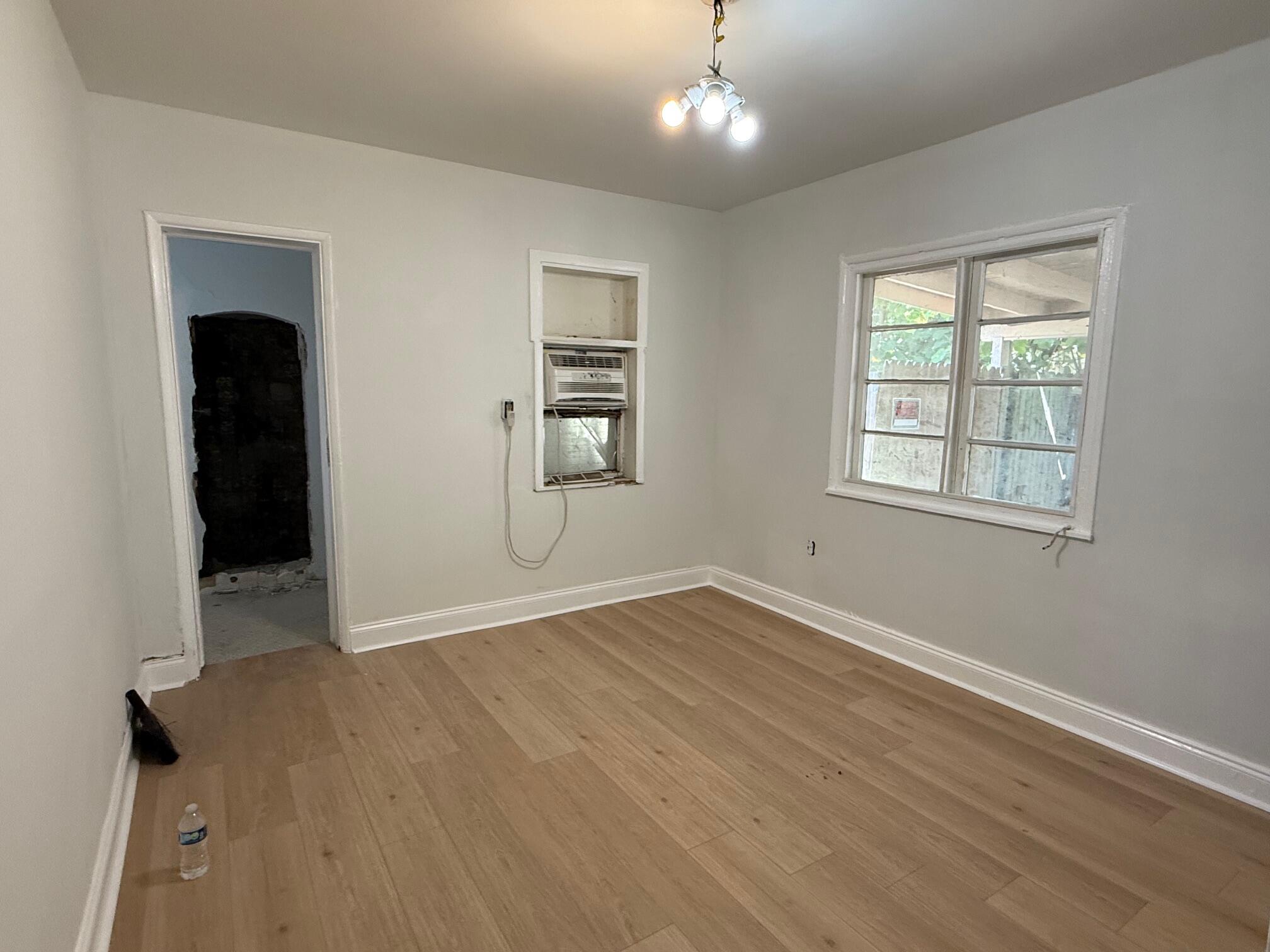 523 48th Street West Palm Beach, FL 33407 - Photo 20 of 33 an empty room with wooden floor and windows