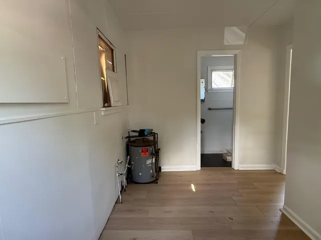 a view of a livingroom with wooden floor and a window