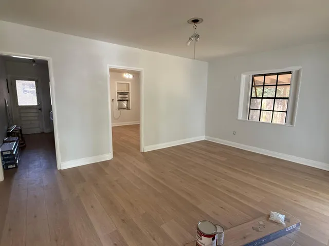 wooden floor in an empty room with a window