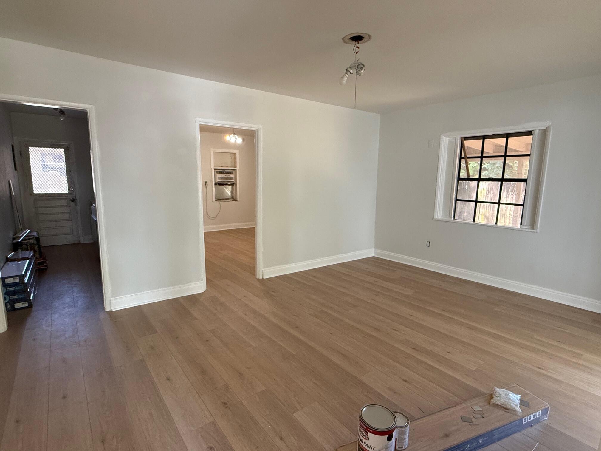 523 48th Street West Palm Beach, FL 33407 - Photo 4 of 33 wooden floor in an empty room with a window