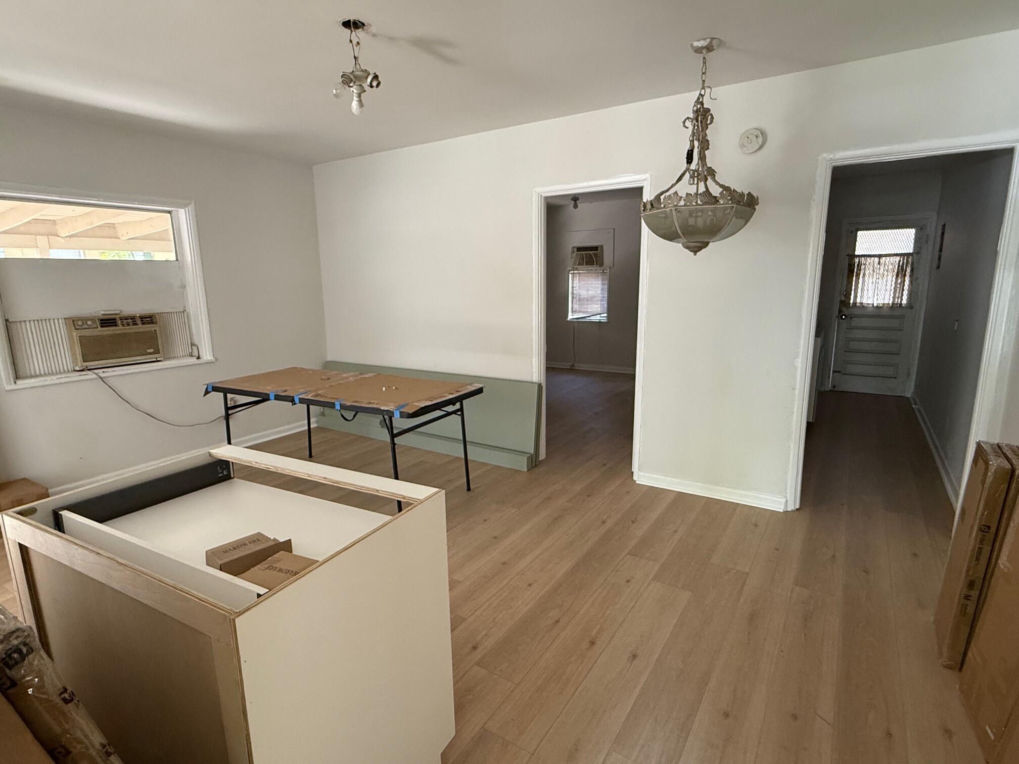523 48th Street West Palm Beach, FL 33407 - Photo 9 of 33 a view of a kitchen with a sink wooden floor and a kitchen view