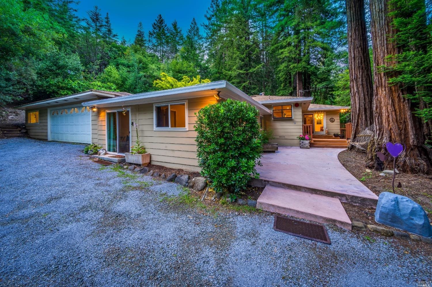 a view of a house with a yard and tree s