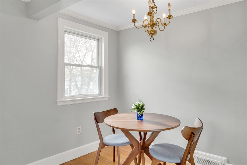 23 Weeks Avenue Boston, MA 02131 - Photo 11 of 34 a view of a dining room with furniture and chandelier