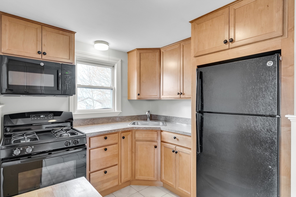 23 Weeks Avenue Boston, MA 02131 - Photo 13 of 34 a kitchen with a refrigerator stove and microwave