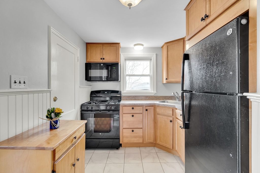 23 Weeks Avenue Boston, MA 02131 - Photo 14 of 34 a kitchen with a sink stove and refrigerator