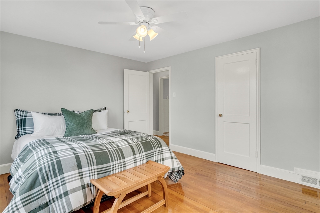 23 Weeks Avenue Boston, MA 02131 - Photo 20 of 34 a bedroom with a bed and wooden floor