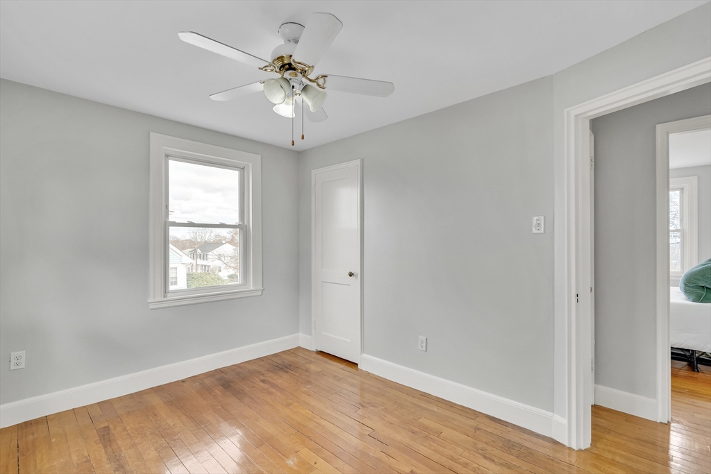 23 Weeks Avenue Boston, MA 02131 - Photo 22 of 34 a view of an empty room with a window and wooden floor