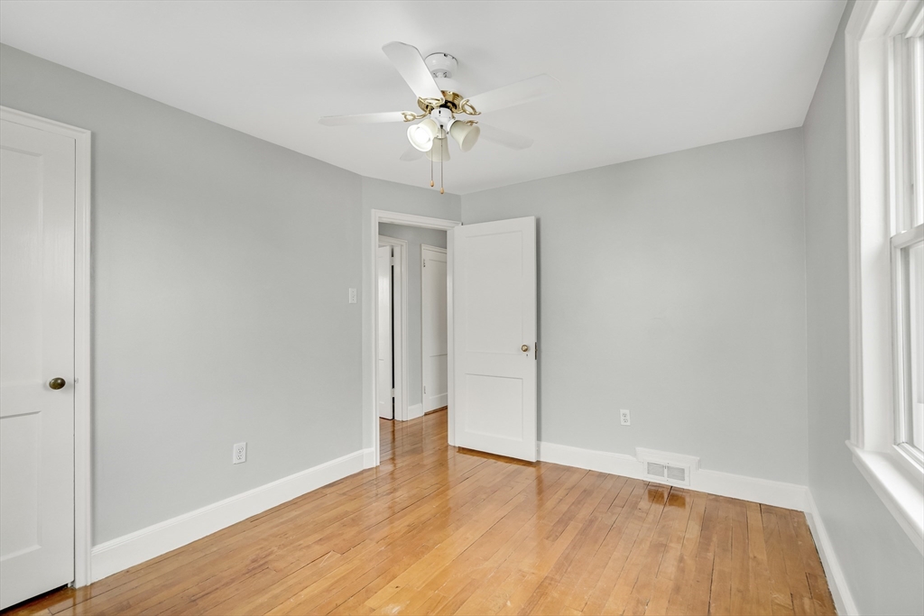 23 Weeks Avenue Boston, MA 02131 - Photo 24 of 34 a view of an empty room with wooden floor and a window