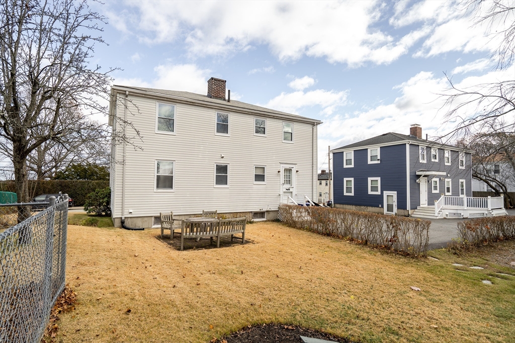 23 Weeks Avenue Boston, MA 02131 - Photo 28 of 34 a view of a white house with a yard covered in snow