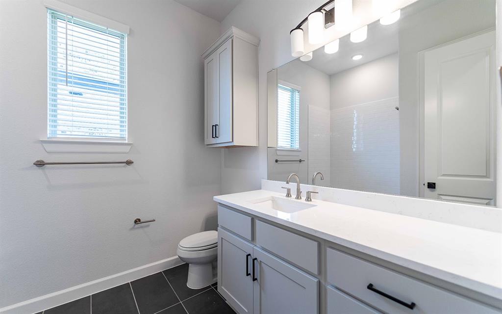 2008 Casting Ridge Mesquite, TX 75181 - Photo 19 of 24 a bathroom with a sink a toilet and a mirror
