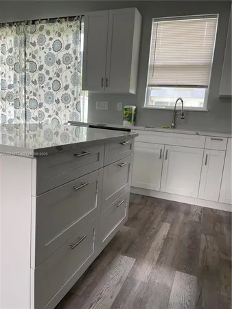 a kitchen with a sink and cabinets