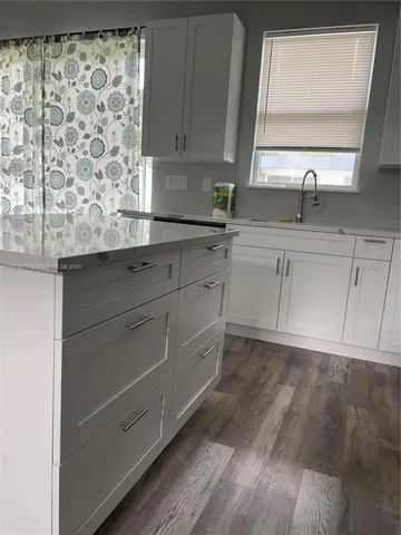 a kitchen with a sink and cabinets