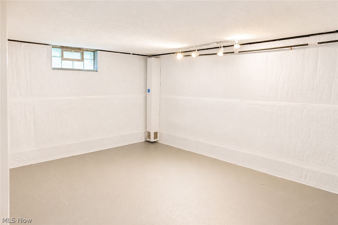 935 Worden Road Wickliffe, OH 44092 - Photo 26 of 27 Concrete flooring with a neutral finish, white wall paneling, and track lighting