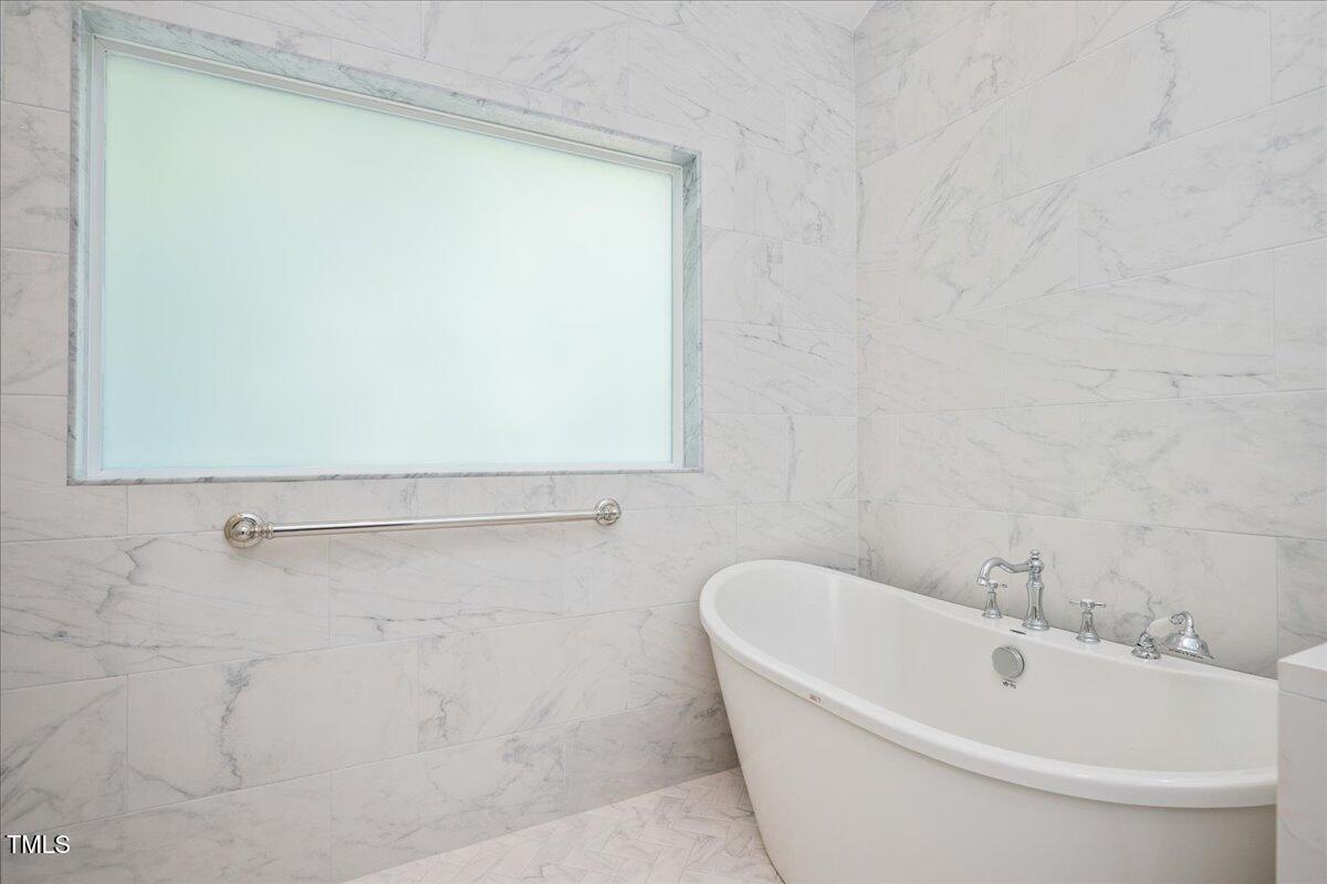 9228 Oneal Road Raleigh, NC 27613 - Photo 13 of 45 a bathroom with a white bath tub and a shower